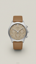Silver Mist Case Chronograph wristwatch, Default angle: elegant 3/4 wrist perspective or watch placed on textured surface...